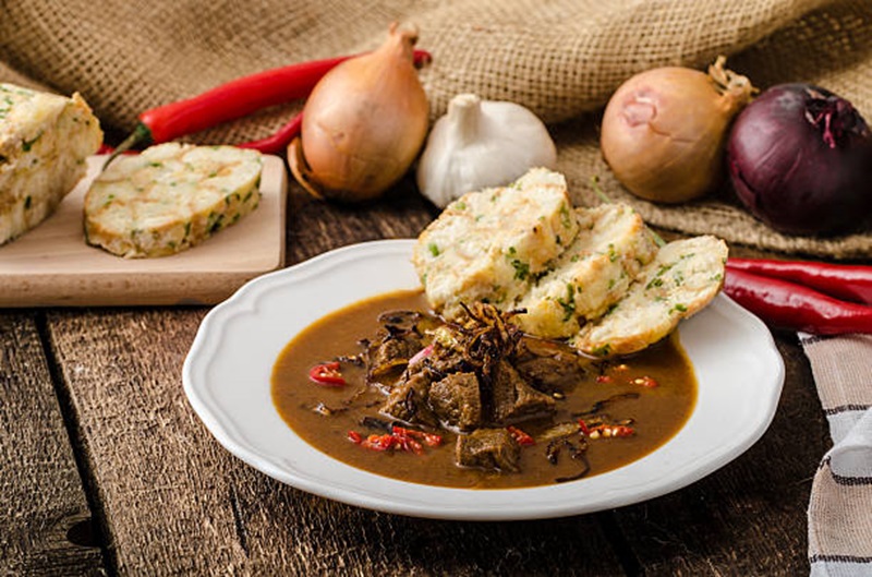 Traditional Czech goulash served with bread dumplings on a plate in Prague, Czech Republic.