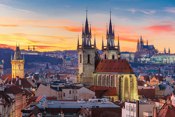 Panoramic view of Prague Castle overlooking the historic city of Prague, Czech Republic, with its iconic towers, cathedral, and red rooftops.